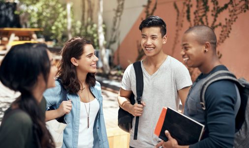 Shot of a group of young men and women hanging out together on campus