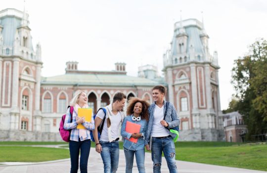 Young smiling students on campus