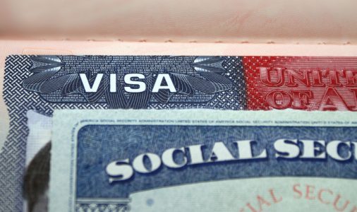 The American visa in a passport page (USA) background and sacial security nember personal document. SSN – social security number for live in America - selective focus